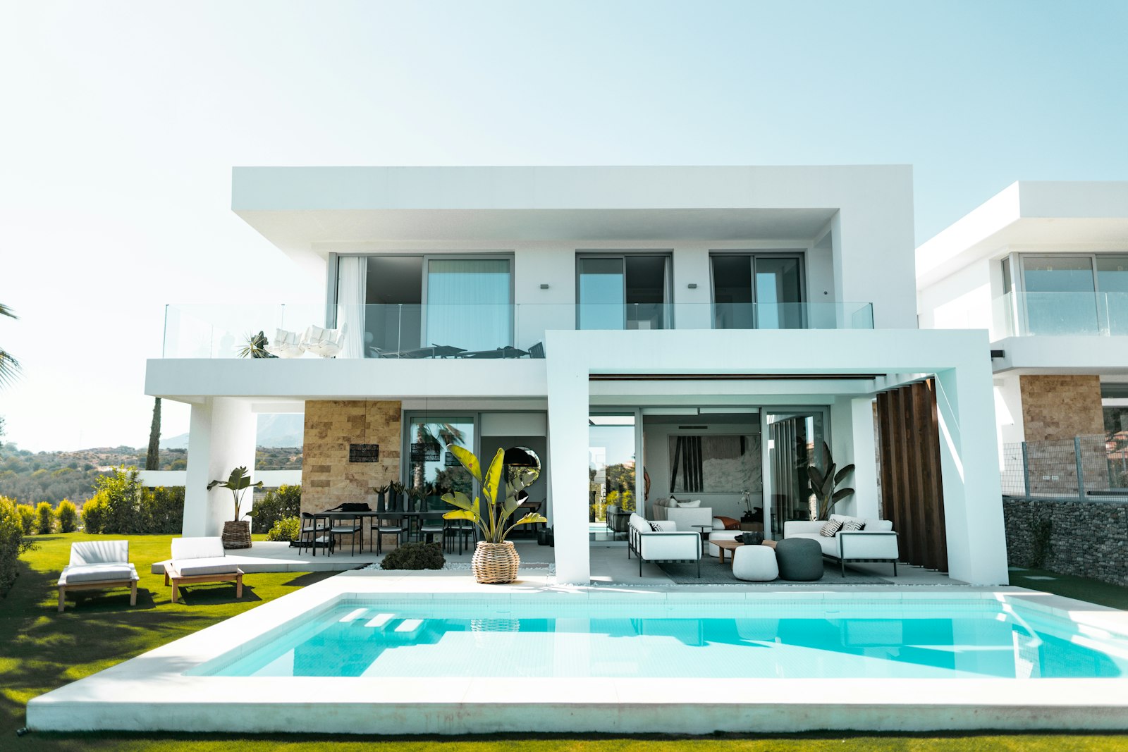 Villa exterior with pool and palm trees